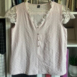 Pink shirt with lace on the v-neck and sleeves slightly used,